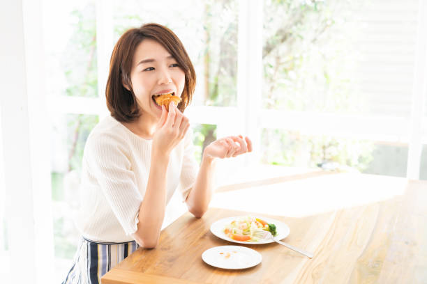 istock attractive asian woman who eats 1333104505
