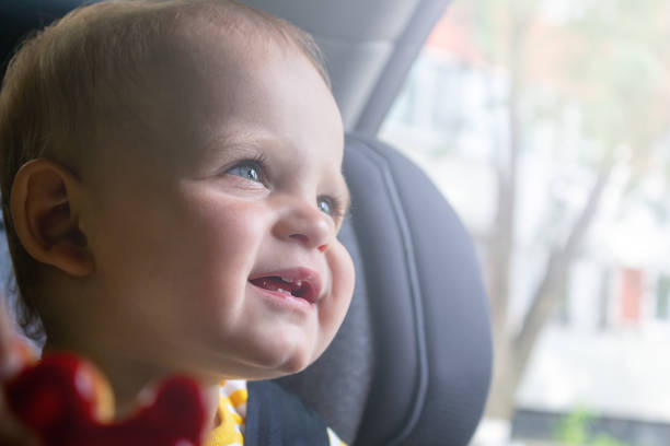 istock Happy baby boy sitting in car seat. 1333114879
