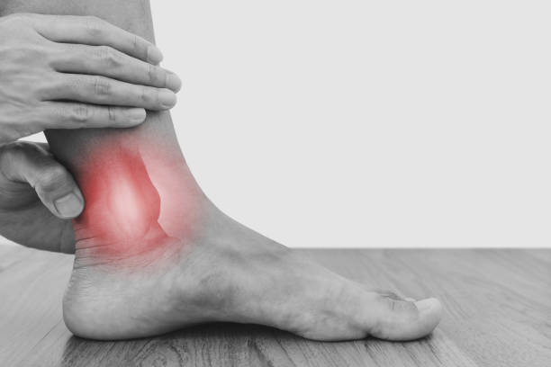 istock Ankle, joint pain, and tendon problem. a man touching ankle 1333115542