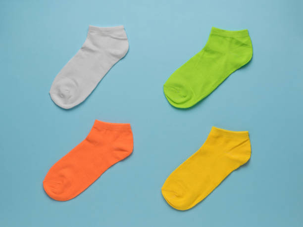 istock Four colorful beautiful socks on a blue background. Flat lay. 1333116426