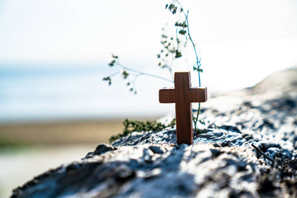 This Sunrise Cross on a misty lake casts a lengthy shadow and reflection on this calm Easter Morning Illustration