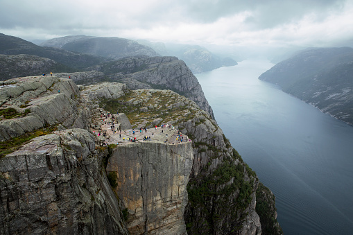 Preikestolen s a tourist attraction in the municipality of Strand in Rogaland county, Norway. Preikestolen is a steep cliff which rises 604 metres (1,982 ft) above Lysefjorden and is famous spot for cliff jumping.