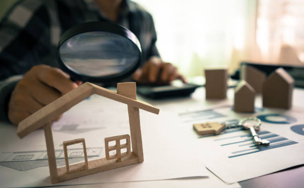 real estate or house appraisal using magnifying glass over the model of a wooden house. concept of house search for housing and apartments. - house human hand choice real estate imagens e fotografias de stock