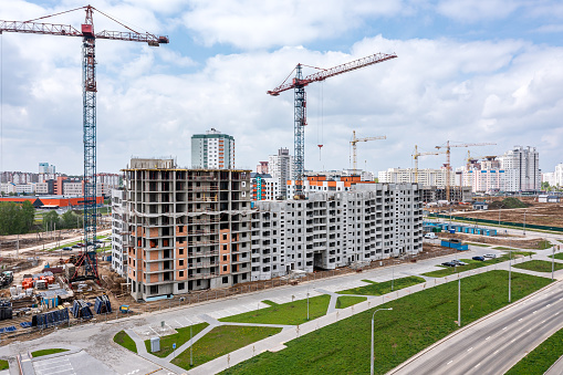 aerial view of construction site of a new residential area with tower cranes.