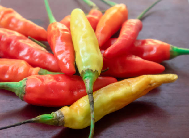 istock Cayenne peppers different kinds sort of pepper color on a  wood background 1333130357