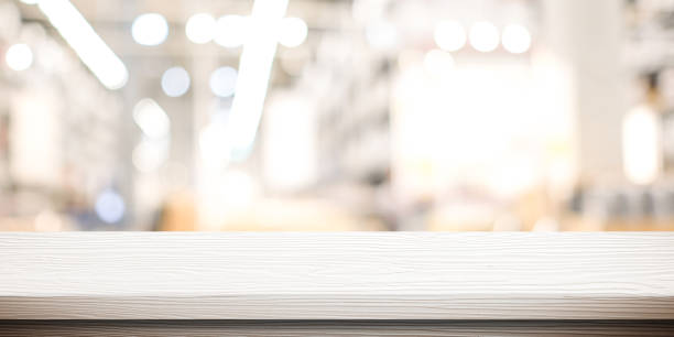 istock White table presentation, desk and blur background, Empty wood counter, shelf surface over blur restaurant white bokeh background, Wood table top for retail shop, store product display banner, mock up 1333130537