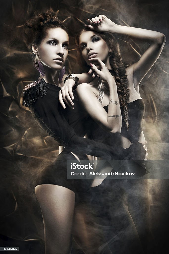 Glam-rock girls in the smoke Two girls dressed in glam-rock style posing in the smoke Adult Stock Photo