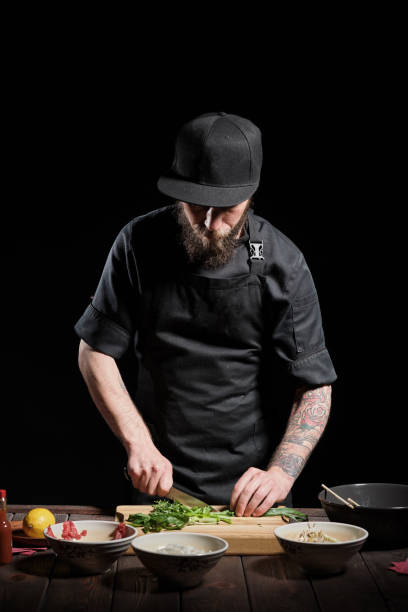 istock Chef cutting greens for cooking 1333133449