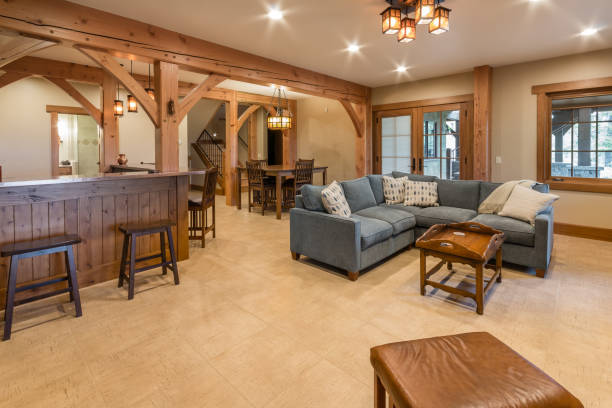 Basement with wood beams and high ceilings Lots of space in new recreation room with kitchenette and bar basement stock pictures, royalty-free photos & images