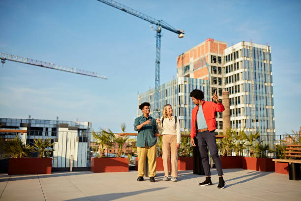 Commercial Real Estate Agent Showing Clients Rooftop Deck