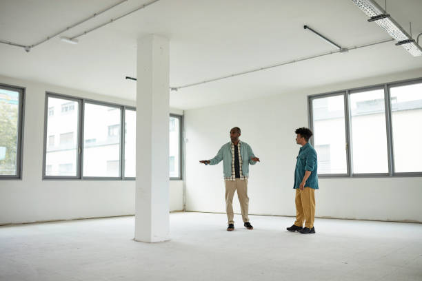 istock Real Estate Agent and Prospective Buyer Touring Office Space 1333137231