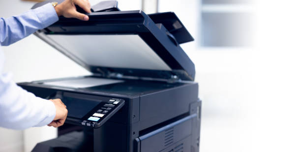 istock Bussiness man Hand press button on panel of printer, printer scanner laser in office copy machine supplies start concept. 1333138121