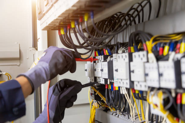 istock Electrician engineer tests electrical installations and wires on relay protection system. Adjustment of scheme of automation and control of electrical equipment. 1333138300