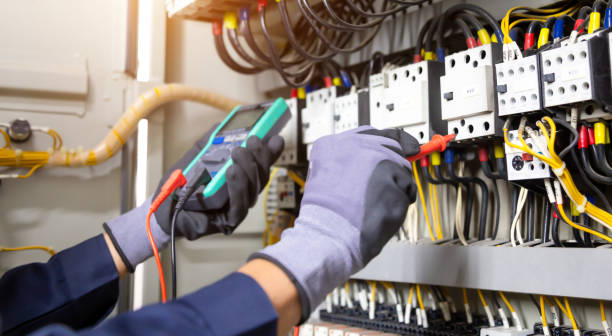 istock Electrician engineer tests electrical installations and wires on relay protection system. Adjustment of scheme of automation and control of electrical equipment. 1333138383