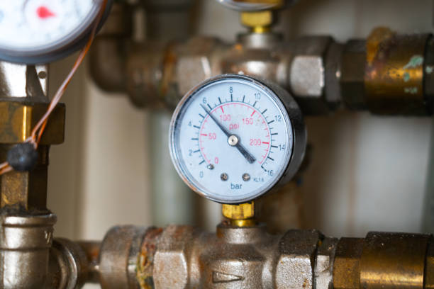 istock Complex piping system with hot analog pressure gauge with dust, dirt, dirty stains. water manifold with manometer and pressure control valve 1333139729