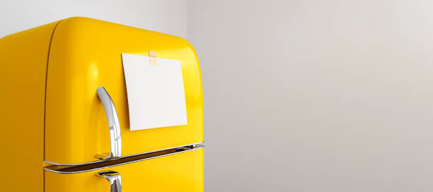 istock blank memo note sticker on yellow refrigerator close up. blank paper reminder on retro fridge door close up mockup 1333141626