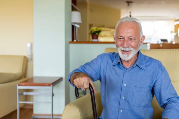 istock Senior Man is Sitting at Home in Deep Thoughts and Smiling. 1333142013