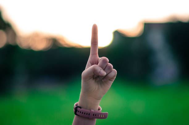 istock Raise up one fingers outdoors 1333144942