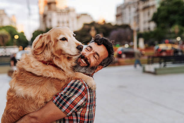 istock Mature man hugging with his golden retriever dog 1333145433