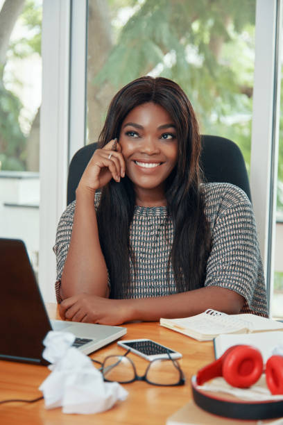 istock Attractive Young Woman Sitting at Desk 1333146367