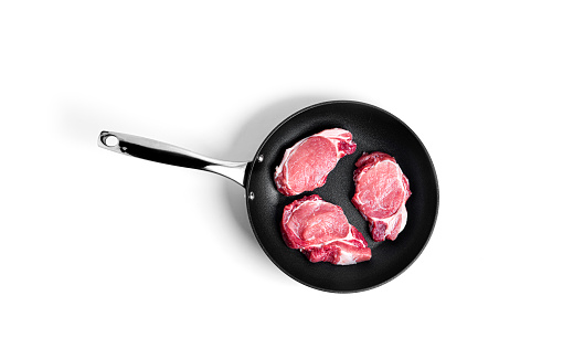 Fresh pork steak on pan isolated on a white background. High quality photo