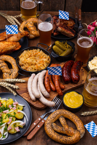 Beer Fest dishes with beer, pretzel and sausage Beer Fest dishes: beer, pretzel, sausage, stewed cabbage, potato salad, half of chicken and ribs weisswurst photos stock pictures, royalty-free photos & images