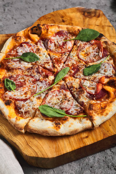 istock Pepperoni Pizza on Wooden Trat with Textile Napkin 1333149482