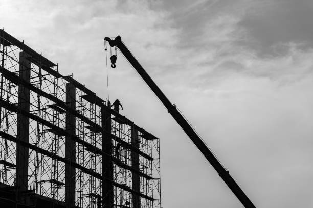 istock Silhouette of construction worker on scaffolding in the construction site 1333149805