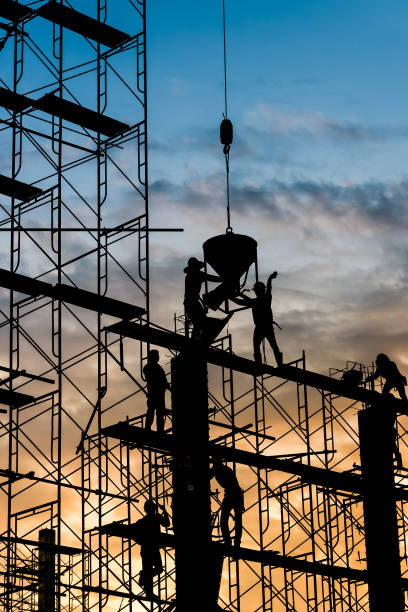 istock Silhouette of worker. Construction Building casting concrete work on scaffolding 1333149806
