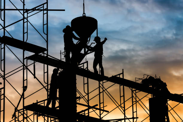 istock Silhouette of worker. Construction Building casting concrete work on scaffolding 1333149807