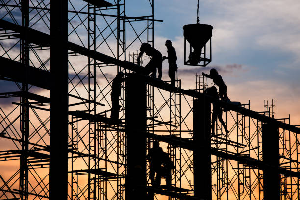 istock Silhouette of worker. Construction Building casting concrete work on scaffolding 1333149809
