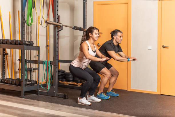 istock People doing squats without weighting exercise in gym 1333150794