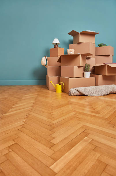 istock Moving boxes, empty wall, and hardwood flooring 1333151157