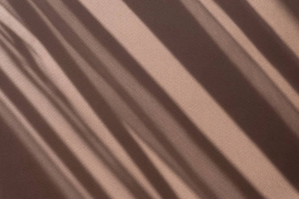 istock Minimalistic abstract brown background with a shadow in form of stripes on surface from sun's rays. Ready-made mockup for your ad 1333151169