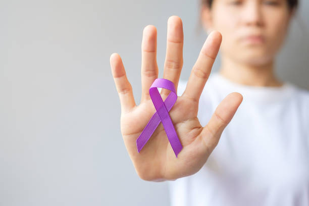 Hand holding purple Ribbon for Pancreatic, Esophageal, Testicular cancer, world Alzheimer, epilepsy, lupus, Sarcoidosis, Fibromyalgia and domestic violence Awareness month. World cancer day concept Hand holding purple Ribbon for Pancreatic, Esophageal, Testicular cancer, world Alzheimer, epilepsy, lupus, Sarcoidosis, Fibromyalgia and domestic violence Awareness month. World cancer day concept june 1 stock pictures, royalty-free photos & images