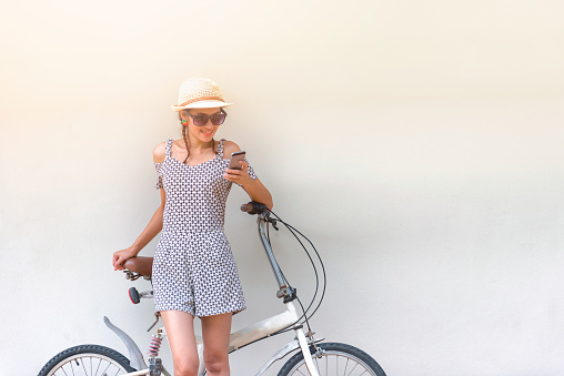 Young woman search directions easily by smartphone for bike riding travel