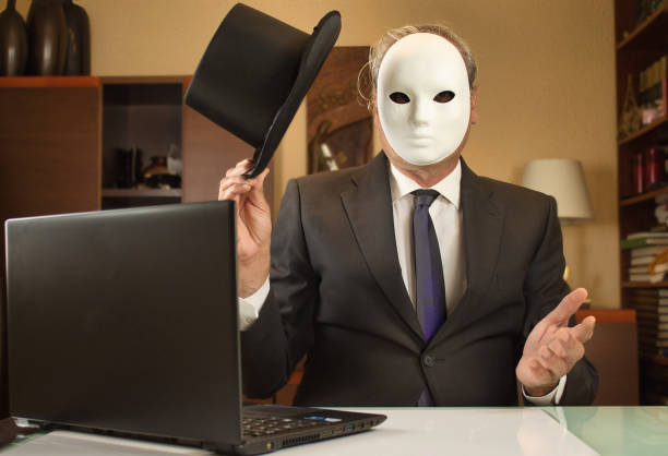 istock anonymous businessman with a mask and hat greets while teleworking from home due to COVID restrictions 1333153290