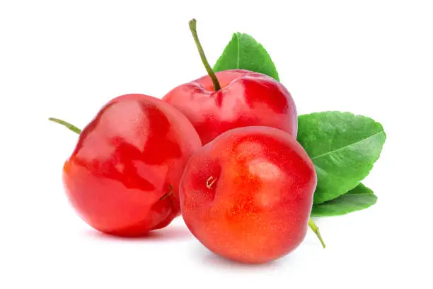 Fresh three red organic acerola cherry fruit (Malpighia Glabra) with green leaf isolated on white background.
