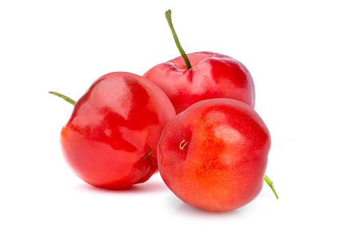 Fresh three red organic acerola cherry fruit (Malpighia Glabra) isolated on white background.
