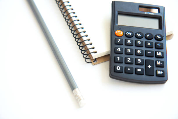 istock Calculator, notebook and pencil isolated on white background 1333156146