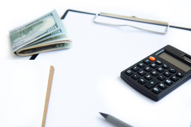 istock Calculator, paper money and notebook isolated on white background 1333156153