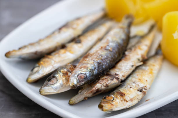 istock fried sardines with boiled potato on white dish 1333157096
