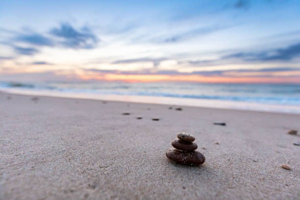 istock Zen stones on calm beach at sunset 1333158262