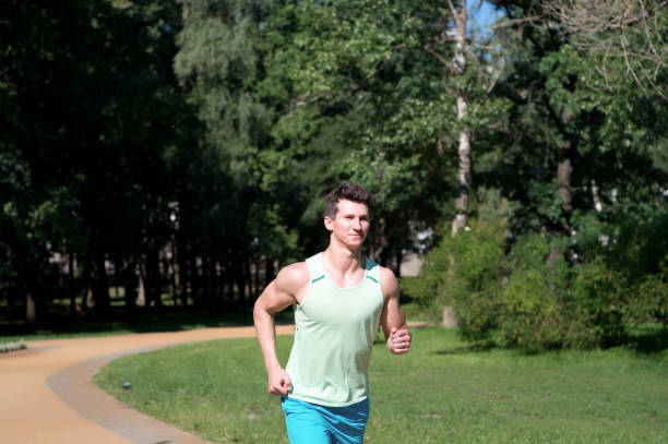 istock Man run in park on sunny summer day 1333158291