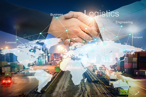 Businessman people shaking hands on agreement of Beneficial for success in logistics with technology line on the world map about cargo transportation services, Import-Export management for logistics