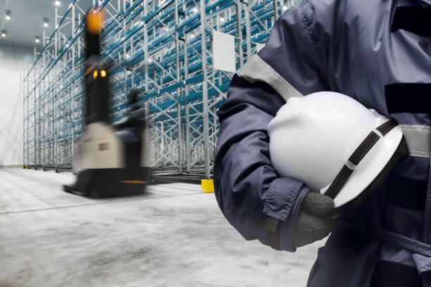 istock Worker in uniform with safety hardhat for dangerous accident protection in warehouse during work 1333158645
