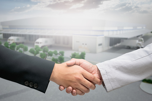 Handshake startup for warehouse construction agreement of logistics partners.