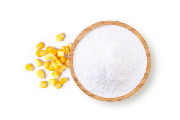 Corn starch in wooden bowl and fresh sweet corn with kernels isolated on white background. Corn starch in wooden bowl and fresh sweet corn with kernels isolated on white background. Top view. Flat lay. starch grain stock pictures, royalty-free photos & images