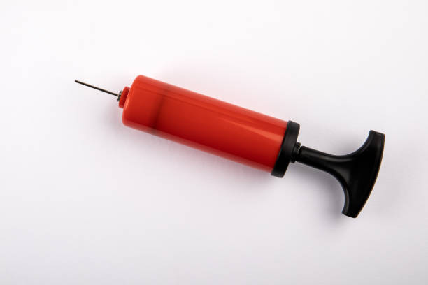 istock Red pump to inflate the ball on a white background 1333162283