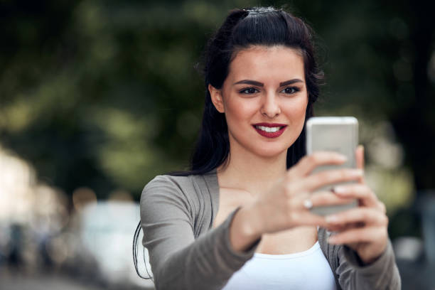 istock Young cute female using smartphone on the street. 1333162394